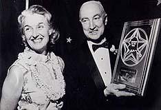 Woman and Man holding award